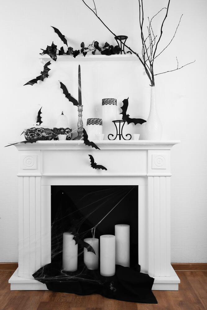 paper bat cut outs on a fireplace mantel