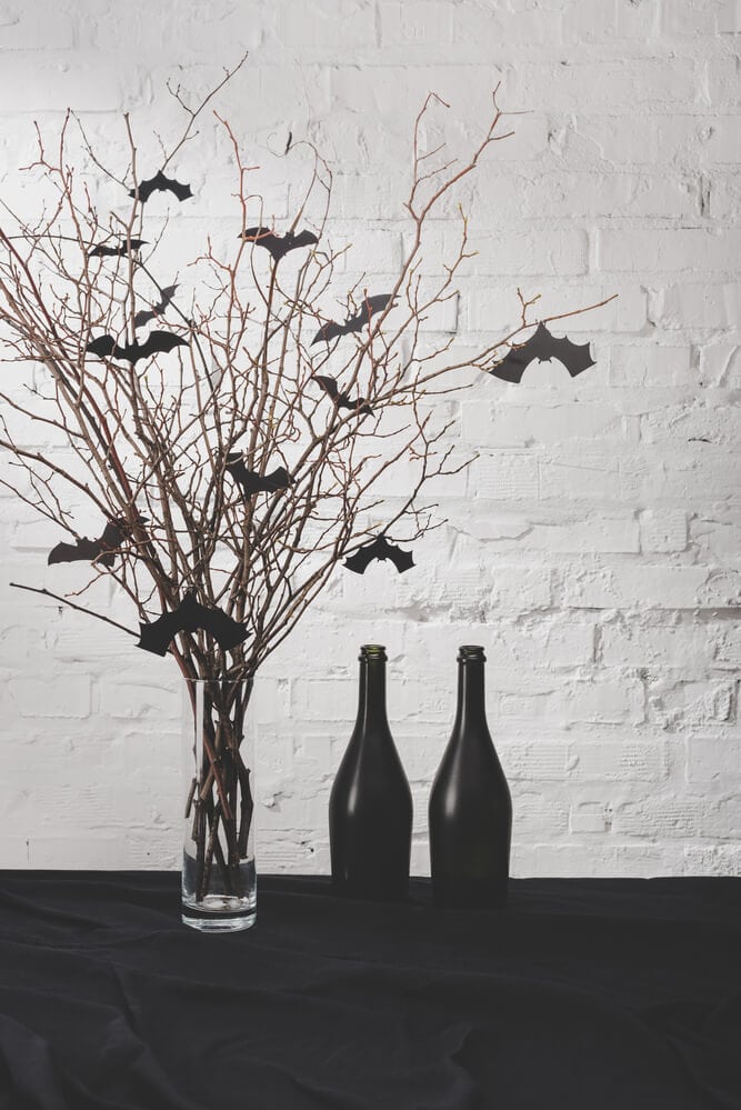 DIY Halloween decor with branches and black bat cut outs in a vase