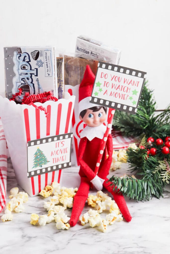 Elf on the Shelf movie night display with popcorn and candy