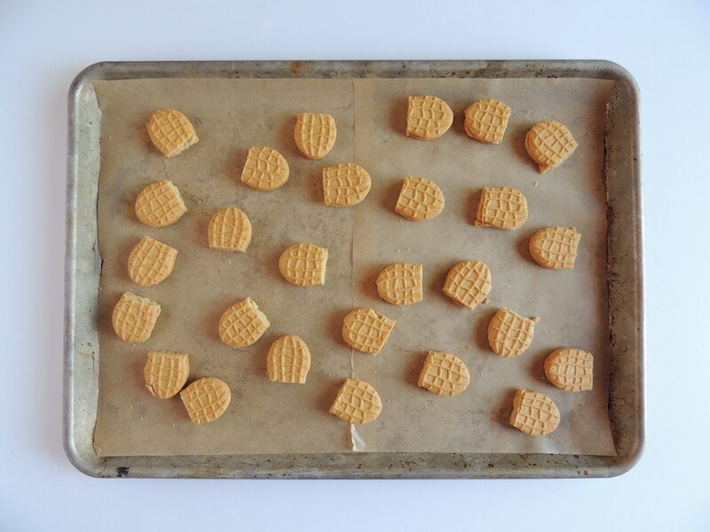 halved nutter butter cookies on a baking sheet
