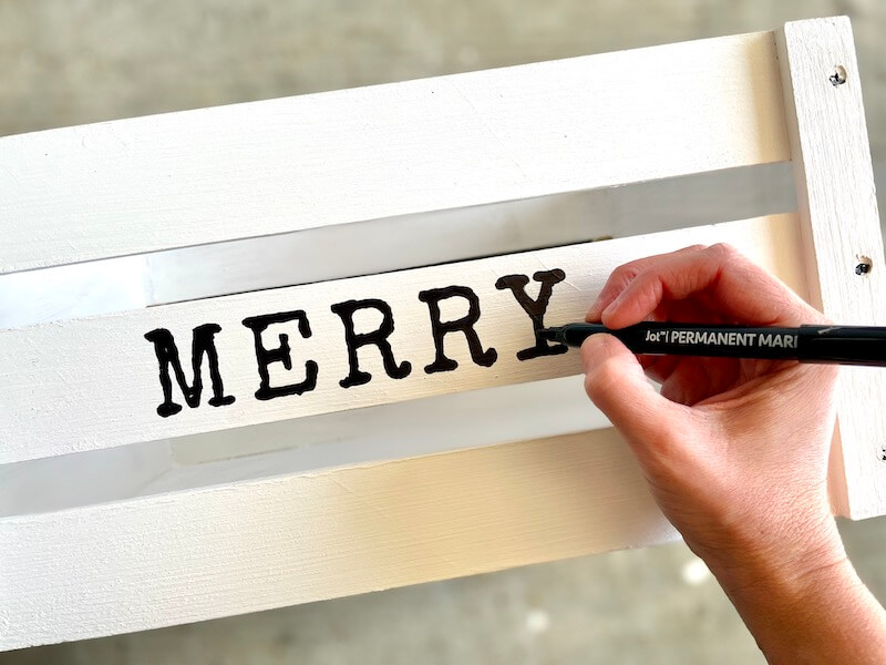 using marker to color in the word merry