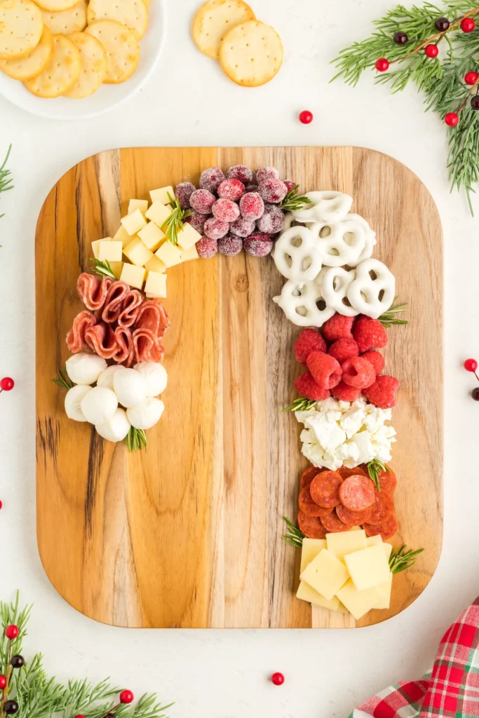 charcuterie board of meats and cheeses shaped like a candy cane