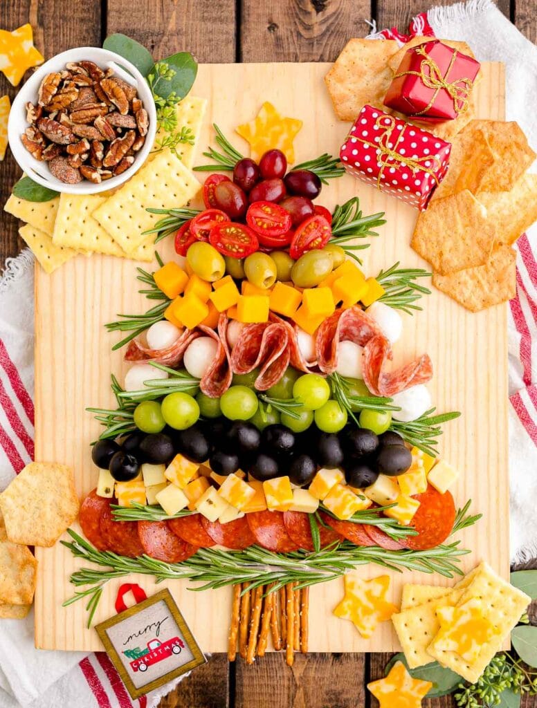 charcuterie board of meats, cheeses, and fruits in the shape of a Christmas tree