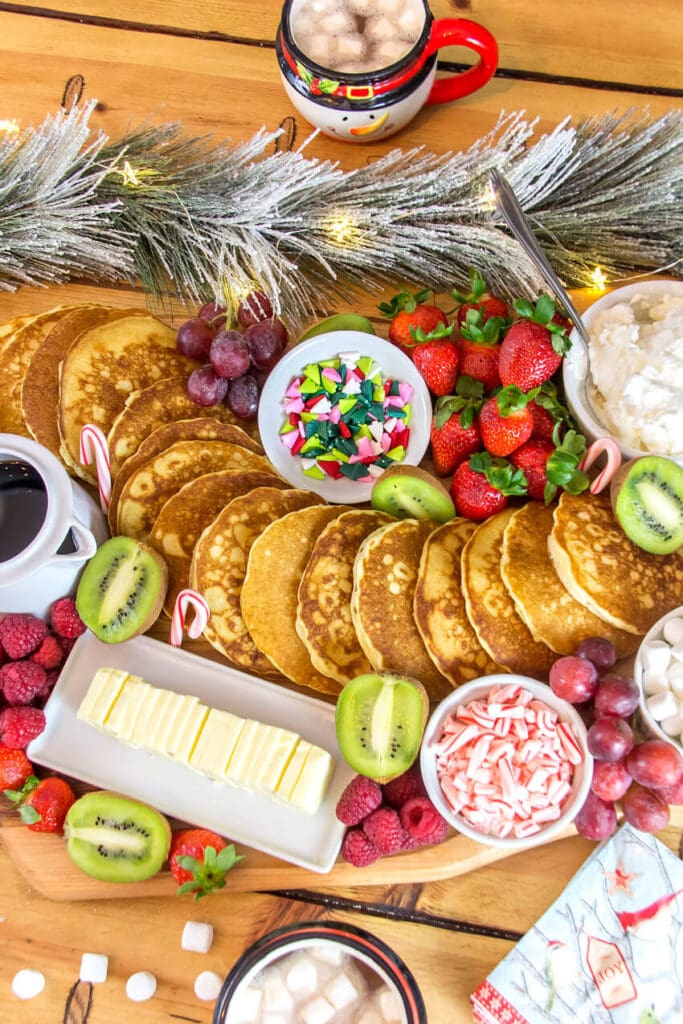 pancakes and other breakfast foods arranged on a cutting board