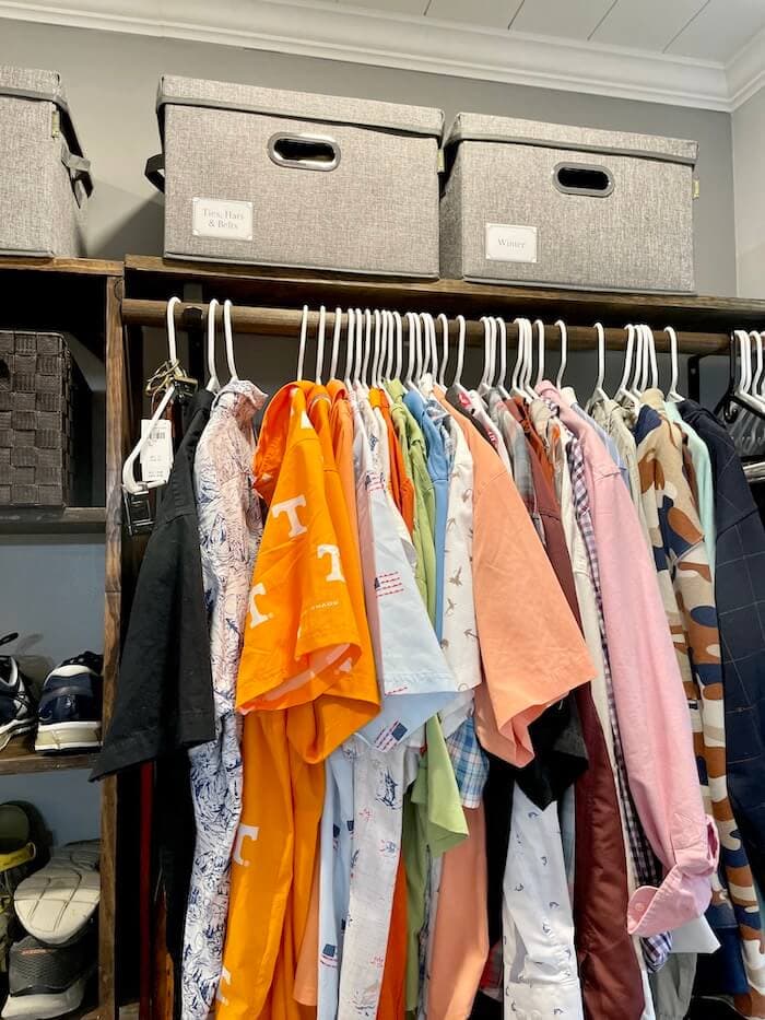 storage bins on the top shelf of a closet