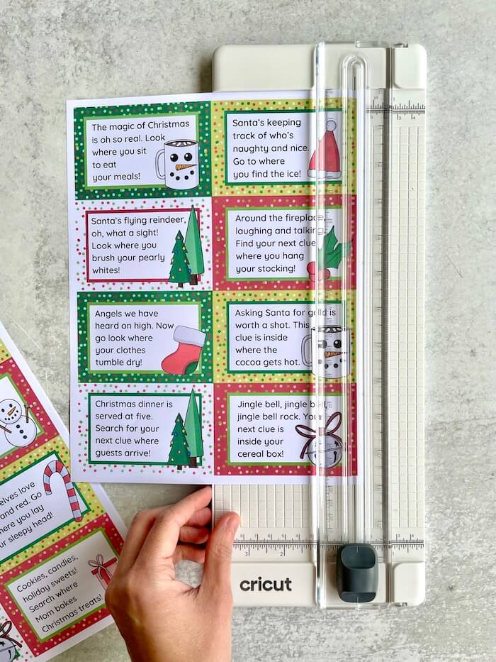 cutting out Christmas scavenger hunt clues