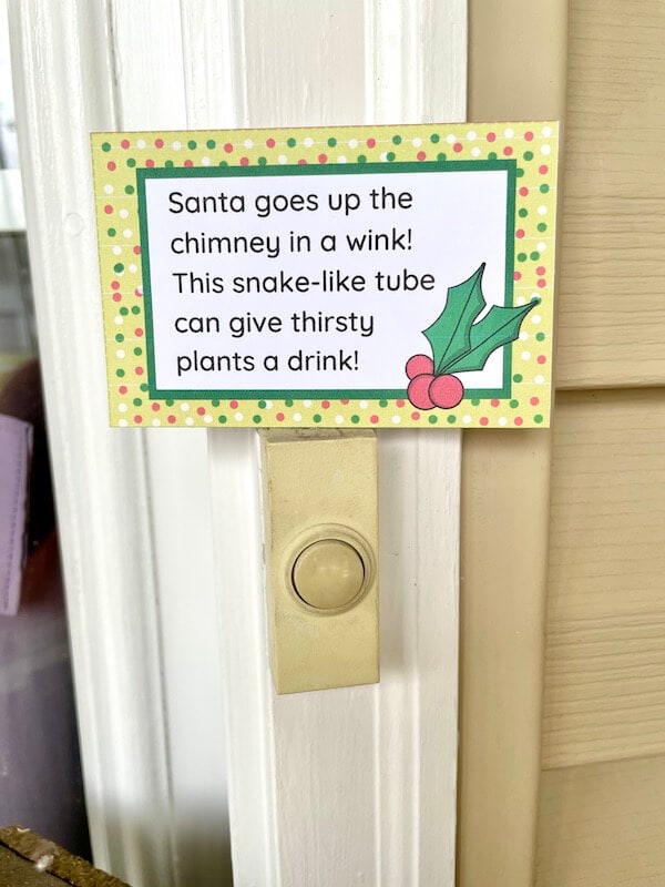 printable Christmas treasure hunt clue taped to a doorbell