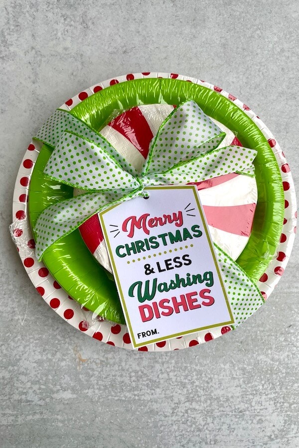 paper plates and napkins wrapped in a bowl with a printable gift tag