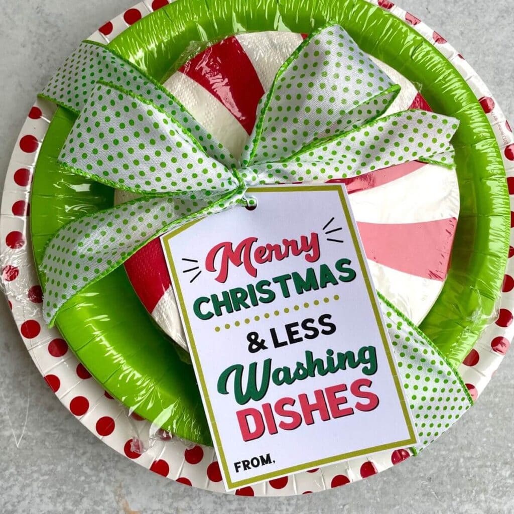 paper plate Christmas gifts with gift tag that says "less dishes"