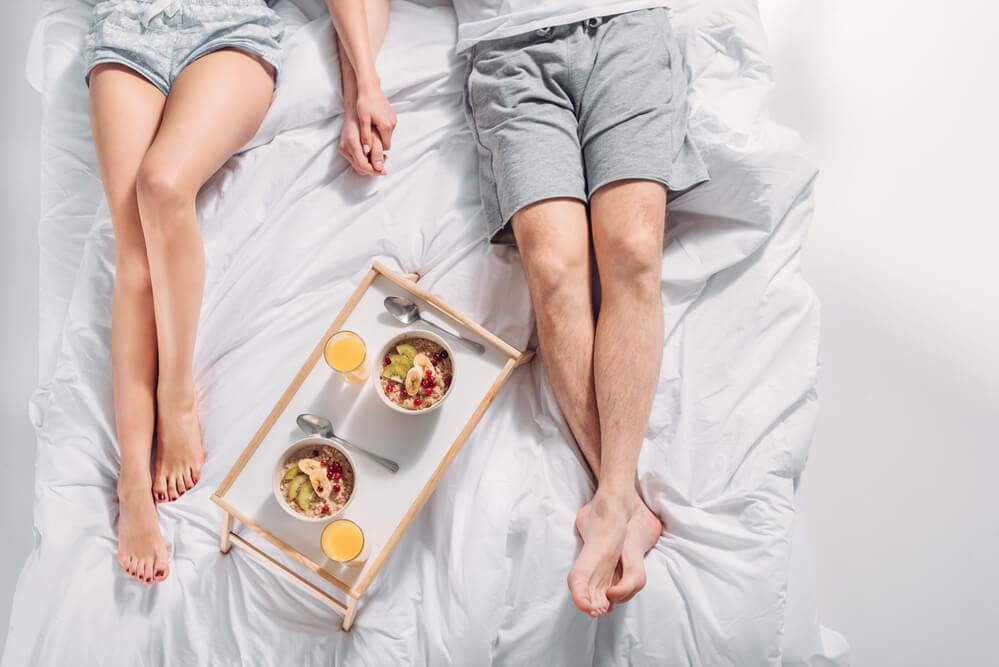 husband and wife with breakfast in bed