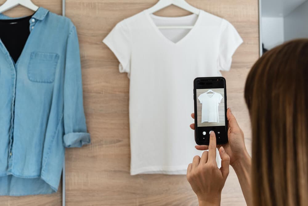 woman taking picture of clothes to sell