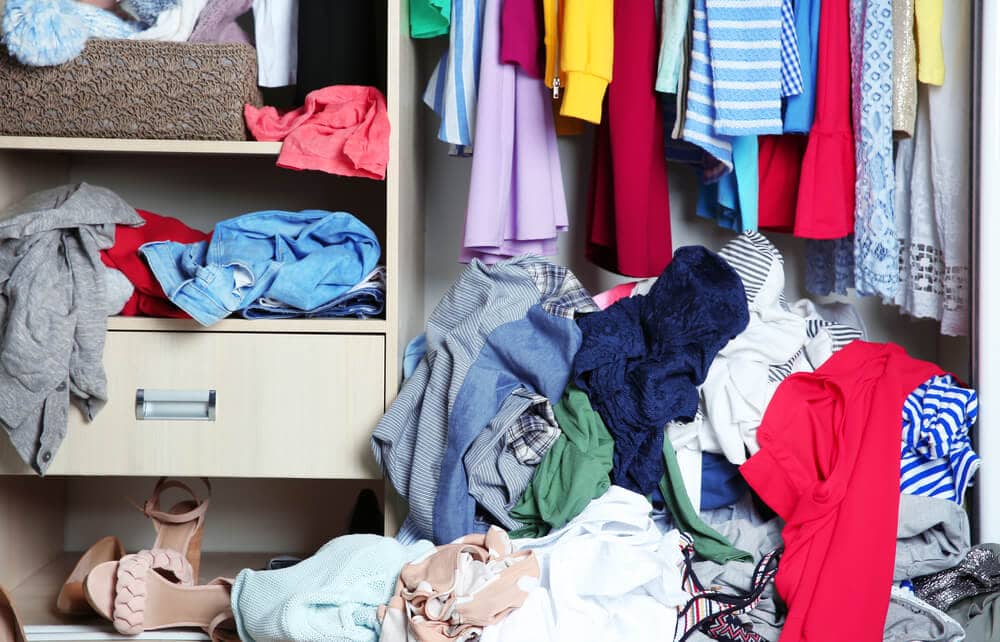 messy cluttered clothing in a closet