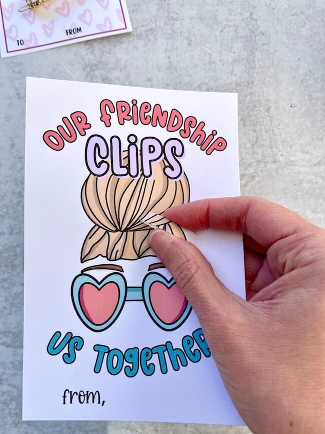 hair clip valentine card with two slits cut into it