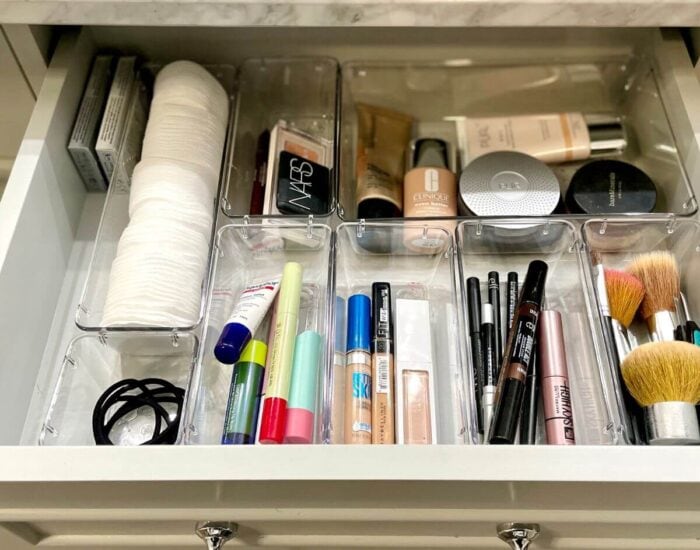 makeup organized in a bathroom drawer with plastic drawer organizers