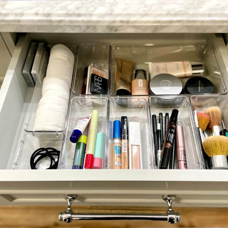 makeup organized in a bathroom drawer with plastic drawer organizers