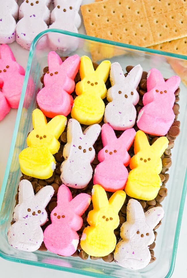 marshmallow Peeps on top of chocolate chips in a baking dish