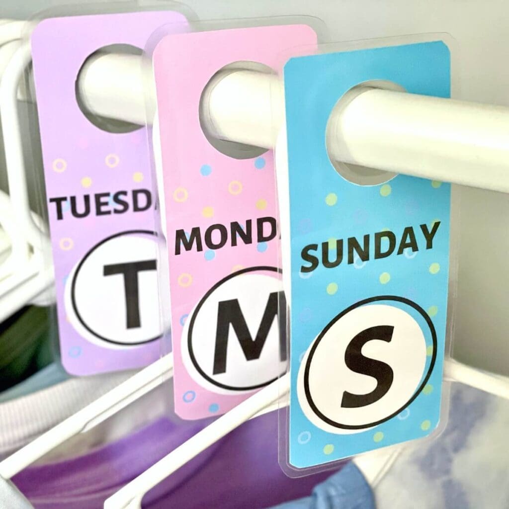 days of the week clothes hanger tags in a girls closet