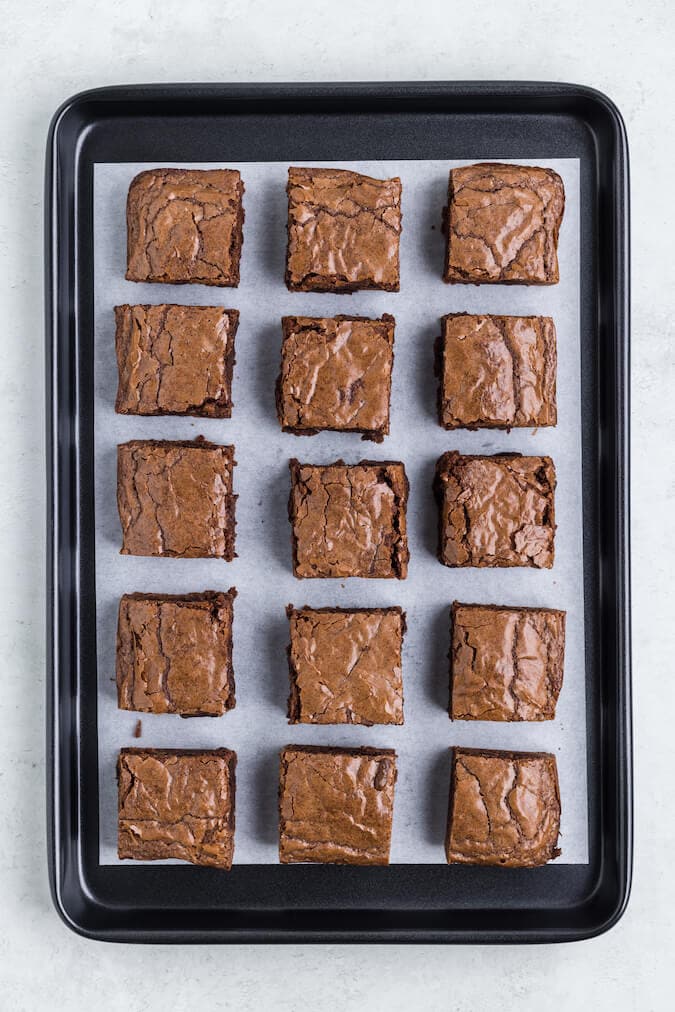 brownies cut into squares on a baking sheet