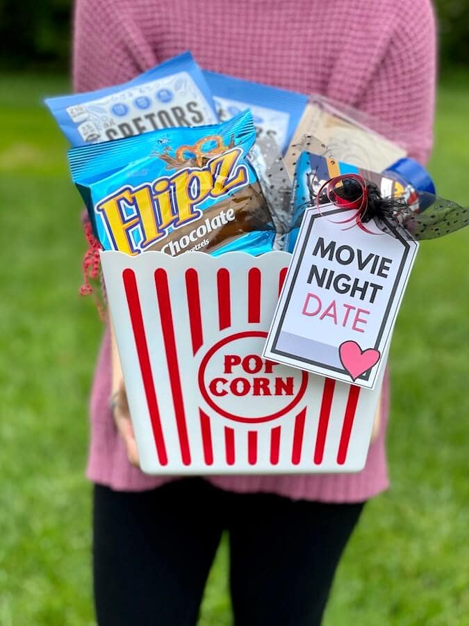 date night gift basket with movie snacks and a printable tag that says movie night date