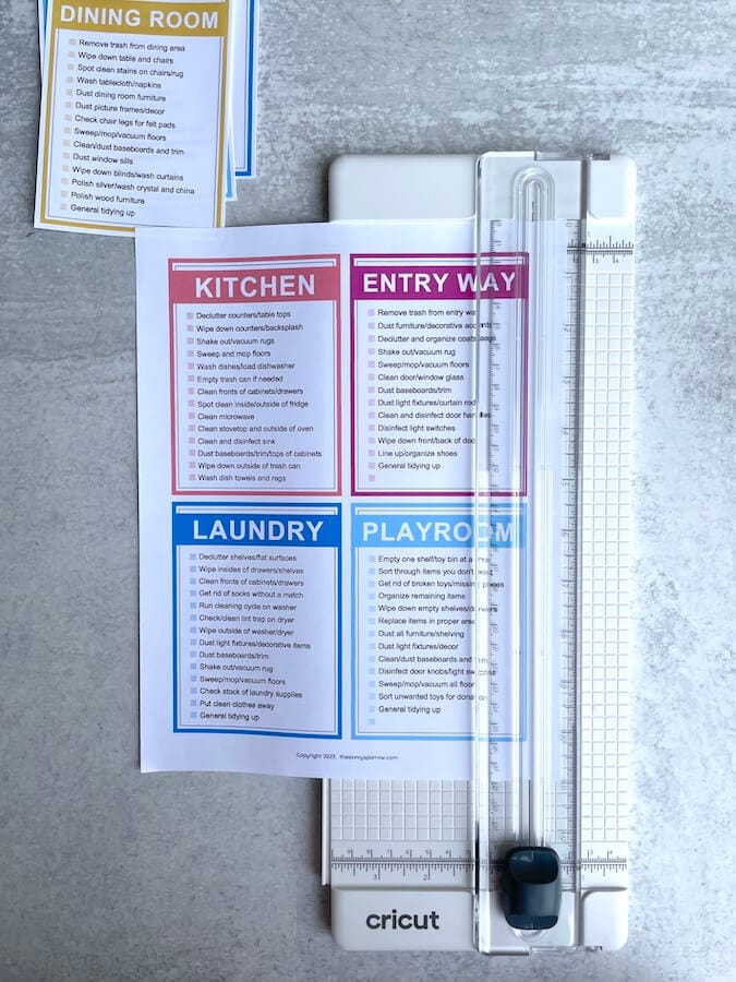 using a paper trimmer to cut chore cards out