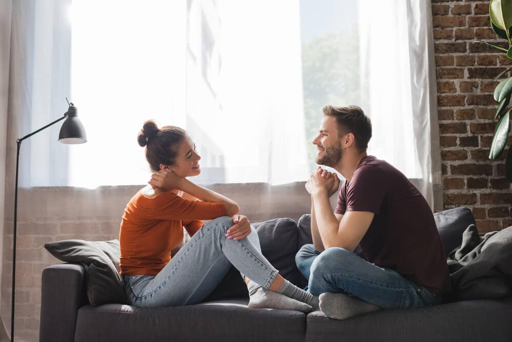 couple sitting on a couch and asking questions