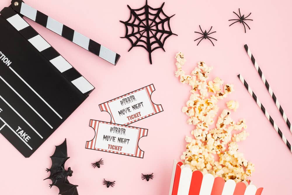 movie clapper, halloween decorations, movie tickets, and popcorn