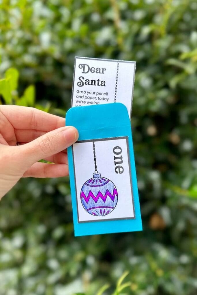 mini envelope for day one of a Christmas activities advent calendar