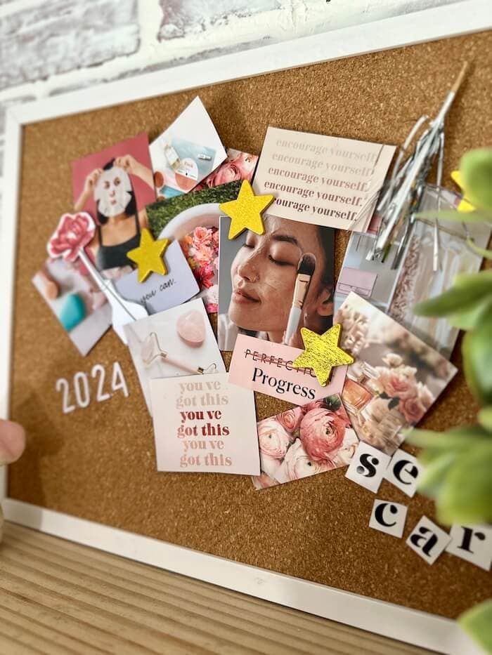vision board on a bulletin board with photos and quotes