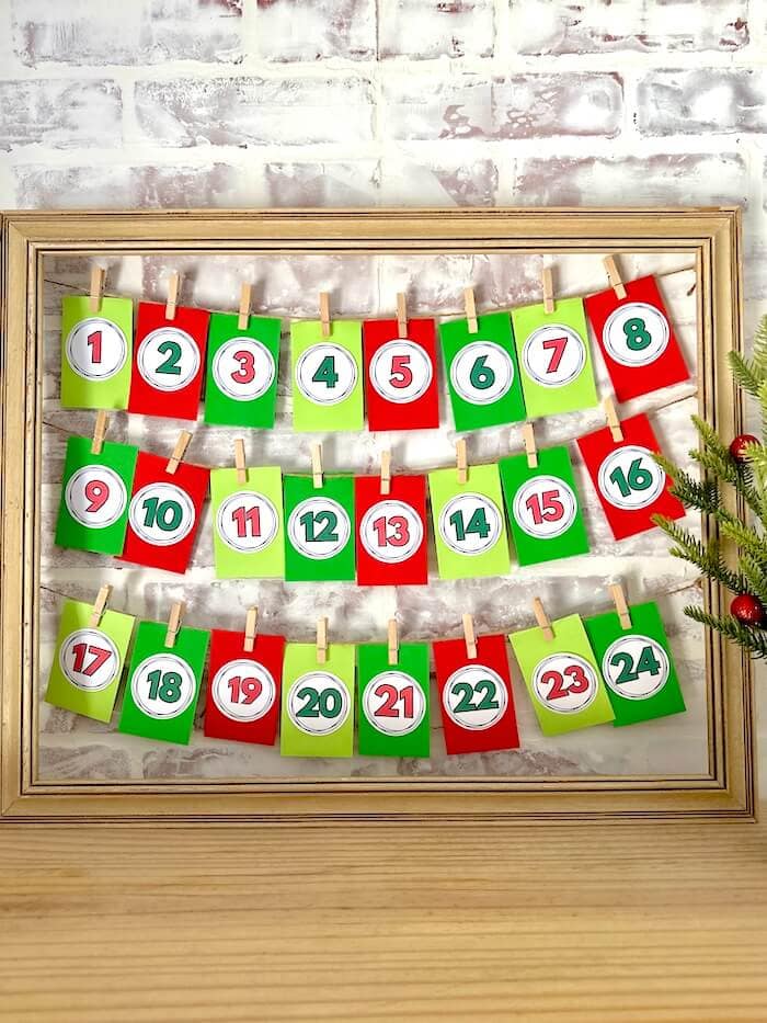 printable advent calendar numbers taped to mini envelopes to create a DIY advent calendar