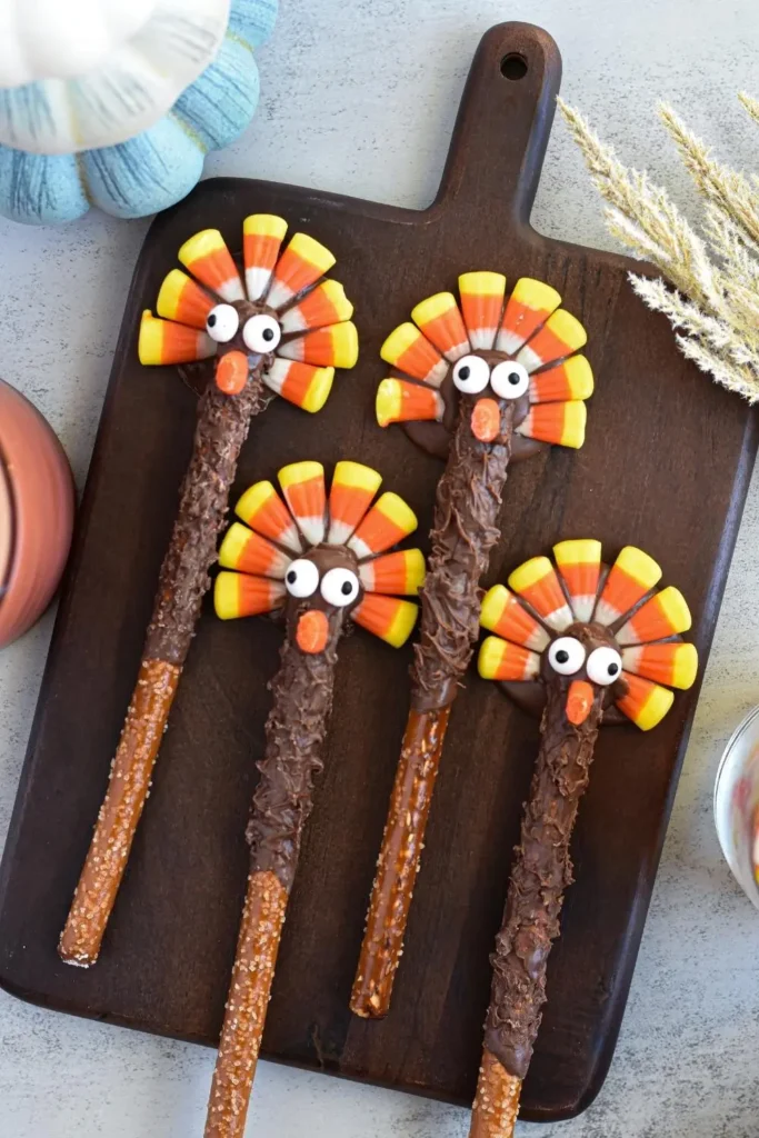 chocolate dipped pretzel rods decorated to look like turkeys
