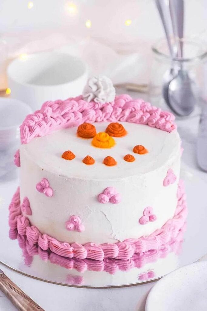small cake decorated like a snowman face