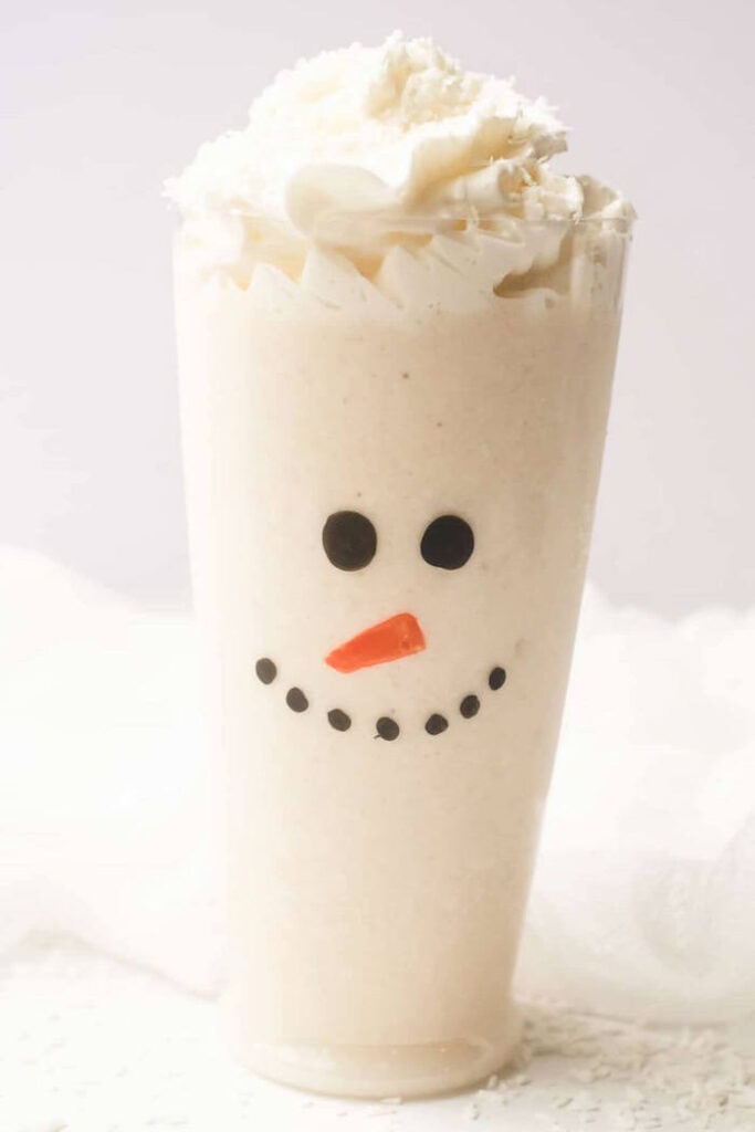 smoothie with a snowman face drawn on the cup