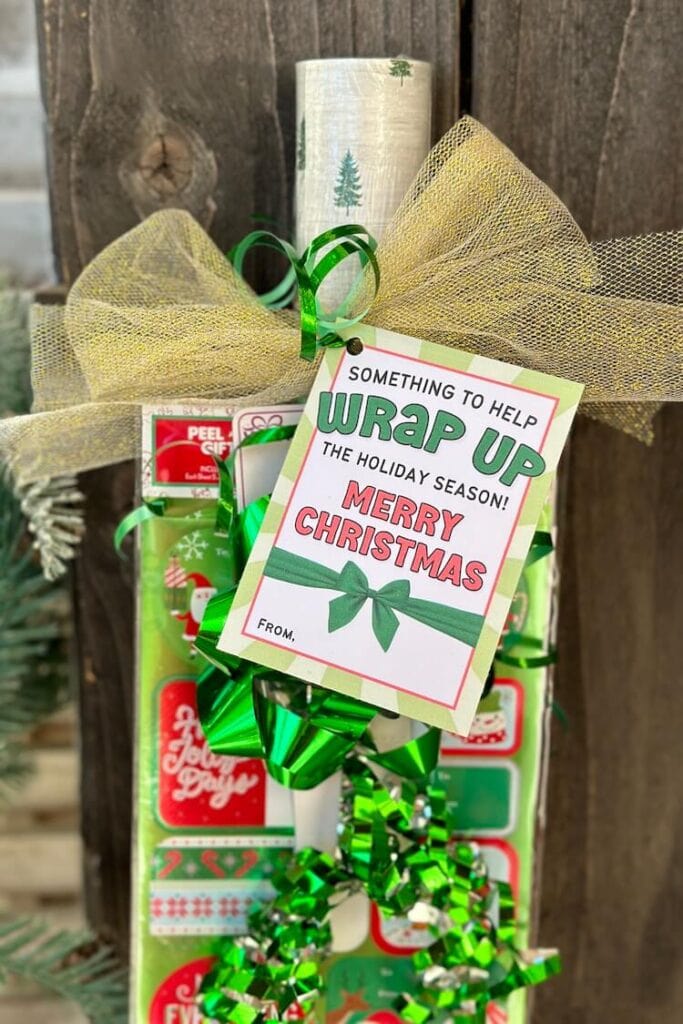printable gift tag that says "Something to help you wrap up the holiday season" tied onto a gift wrap neighbor gift