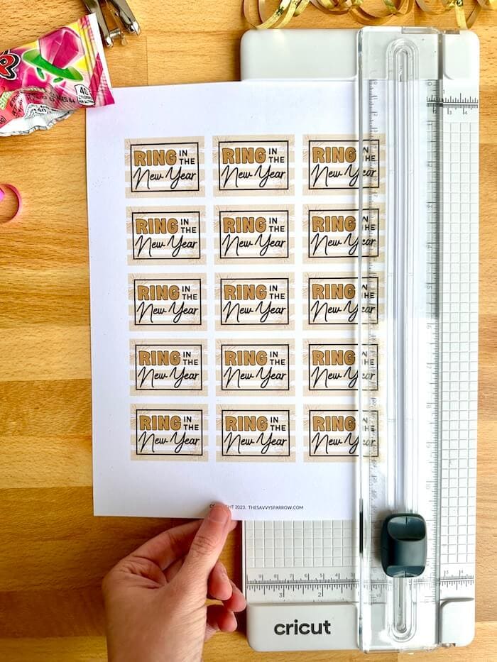 using a paper trimmer to cut printable New Year's eve favor gift tags
