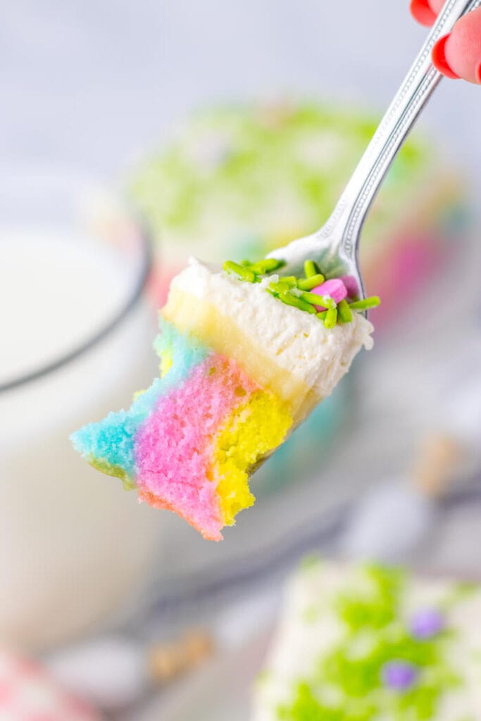 bite of Spring colored poke cake on a fork