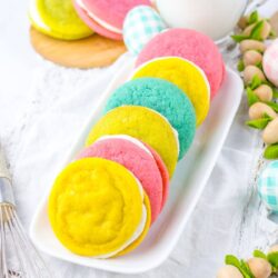 Easter sandwich cookies that are pastel colors with buttercream icing