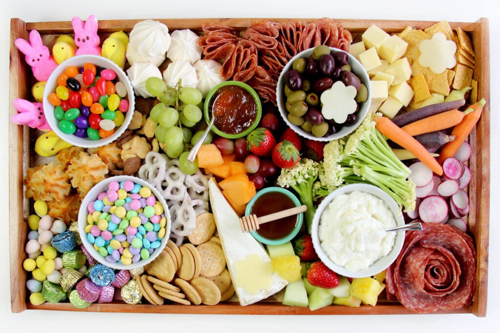 Easter snack board with fruits, vegetables, and other snacks