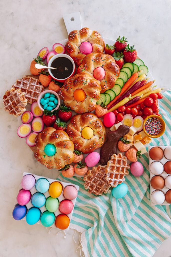 brunch board with colored Easter eggs, waffles, and brunch food items