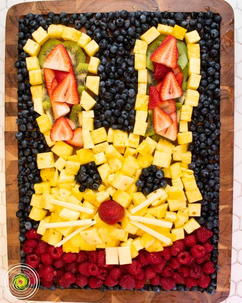 cheese and fruit arranged in the shape of a bunny