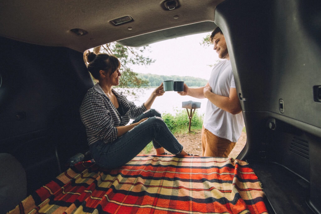 couple having a picnic in the back of a car