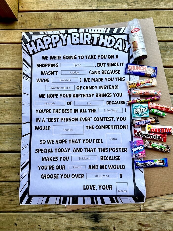 printable birthday candy sign, candy bars, and a large piece of cardboard