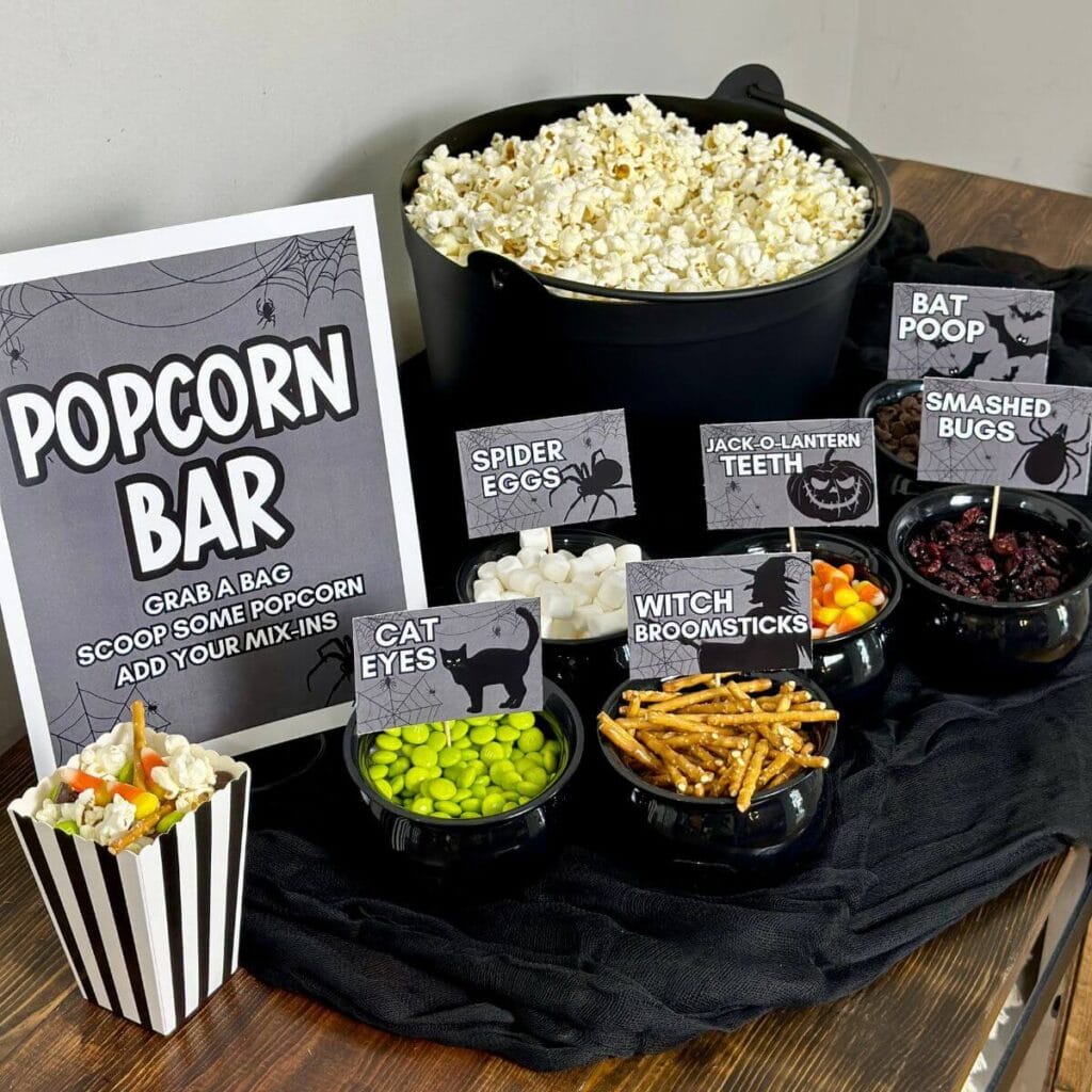 Halloween popcorn bar with printable signs and popcorn mix-ins