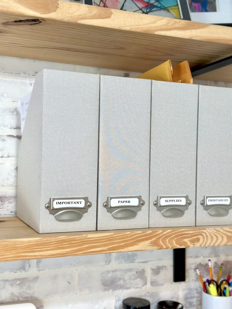 magazine file holders on a shelf in a home office