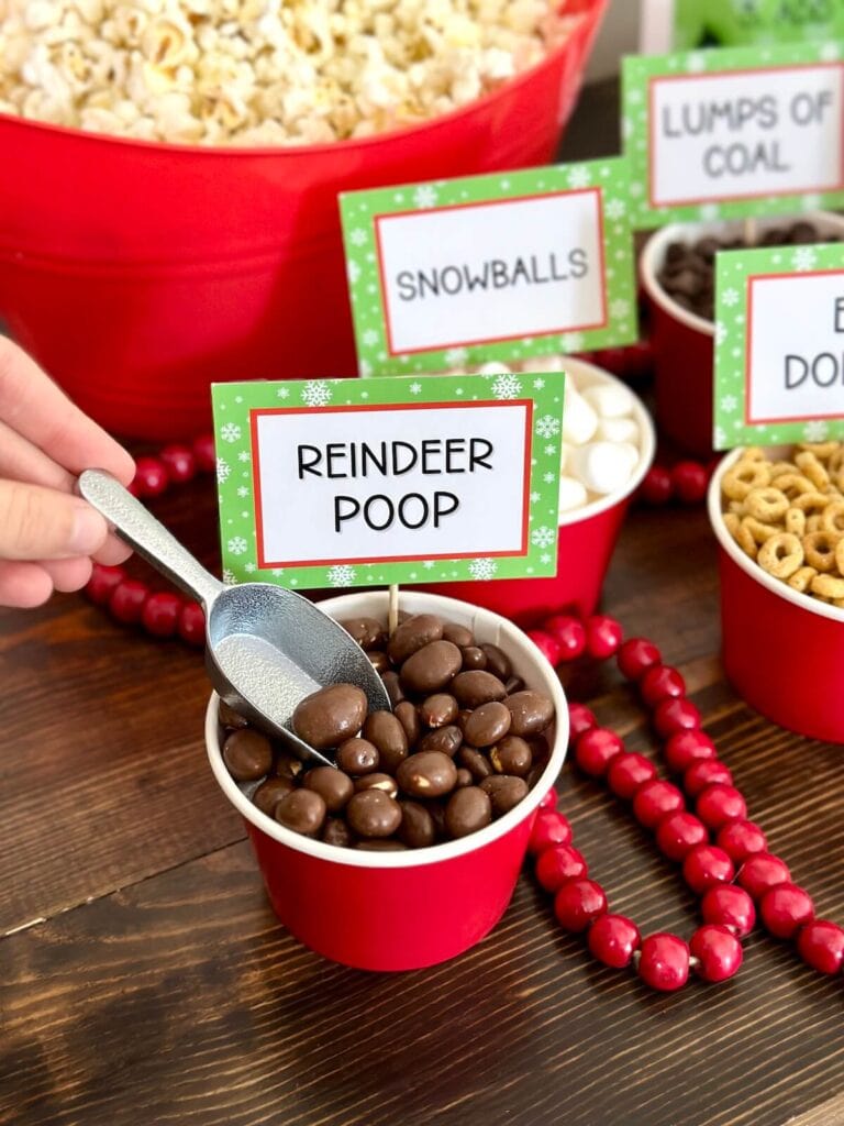 chocolate covered raisins in a cup with a sign that says reindeer poop