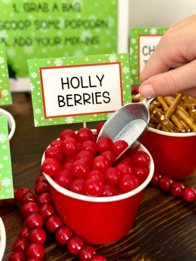 red candy in a cup with a sign that says holly berries