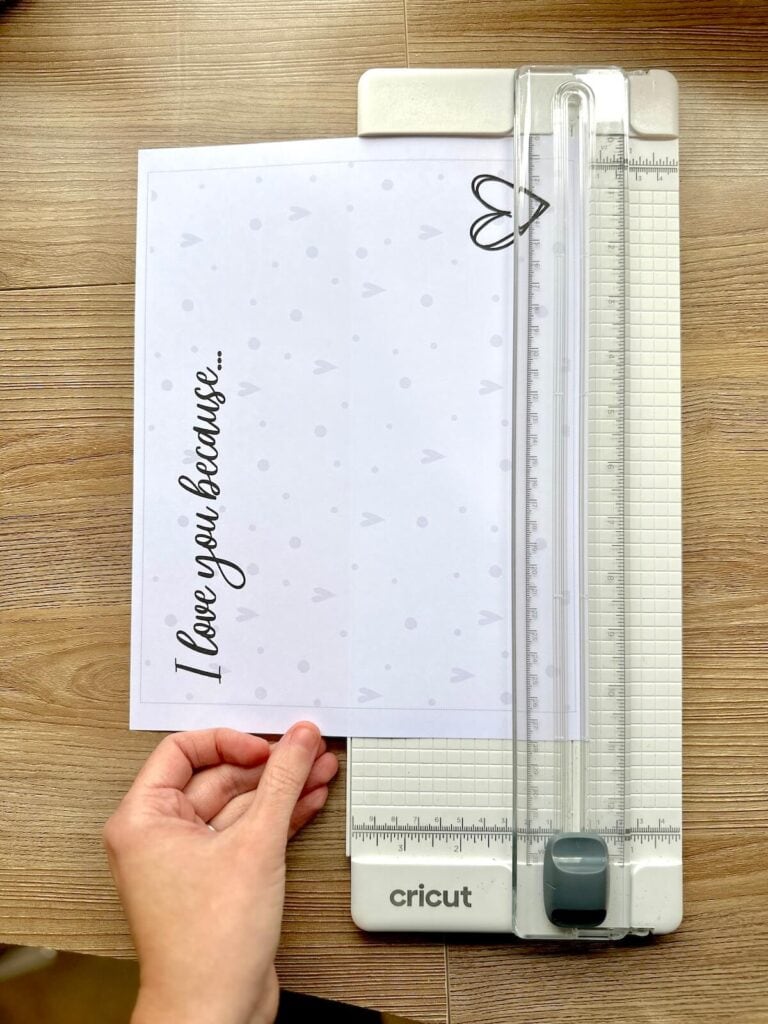 cutting out a piece of paper that says I love you because