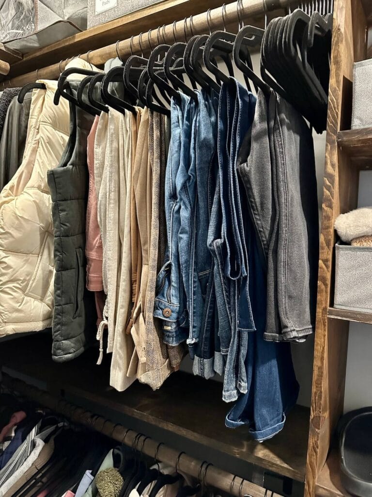hanging clothes organized by color and type
