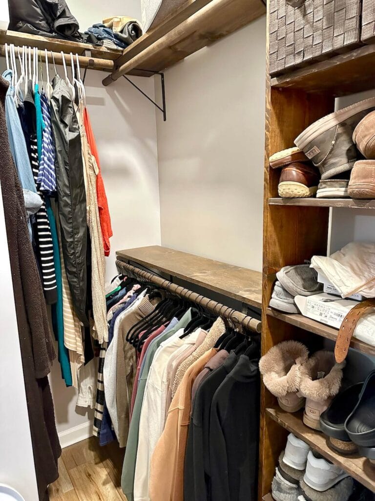 one empty closet hanging rod in a master closet