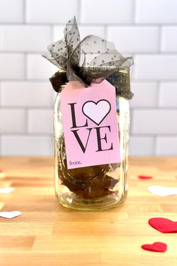 Valentine gift tag tied on to a jar with chocolates