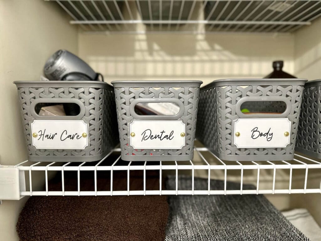 storage baskets in a closet with labels for organizing